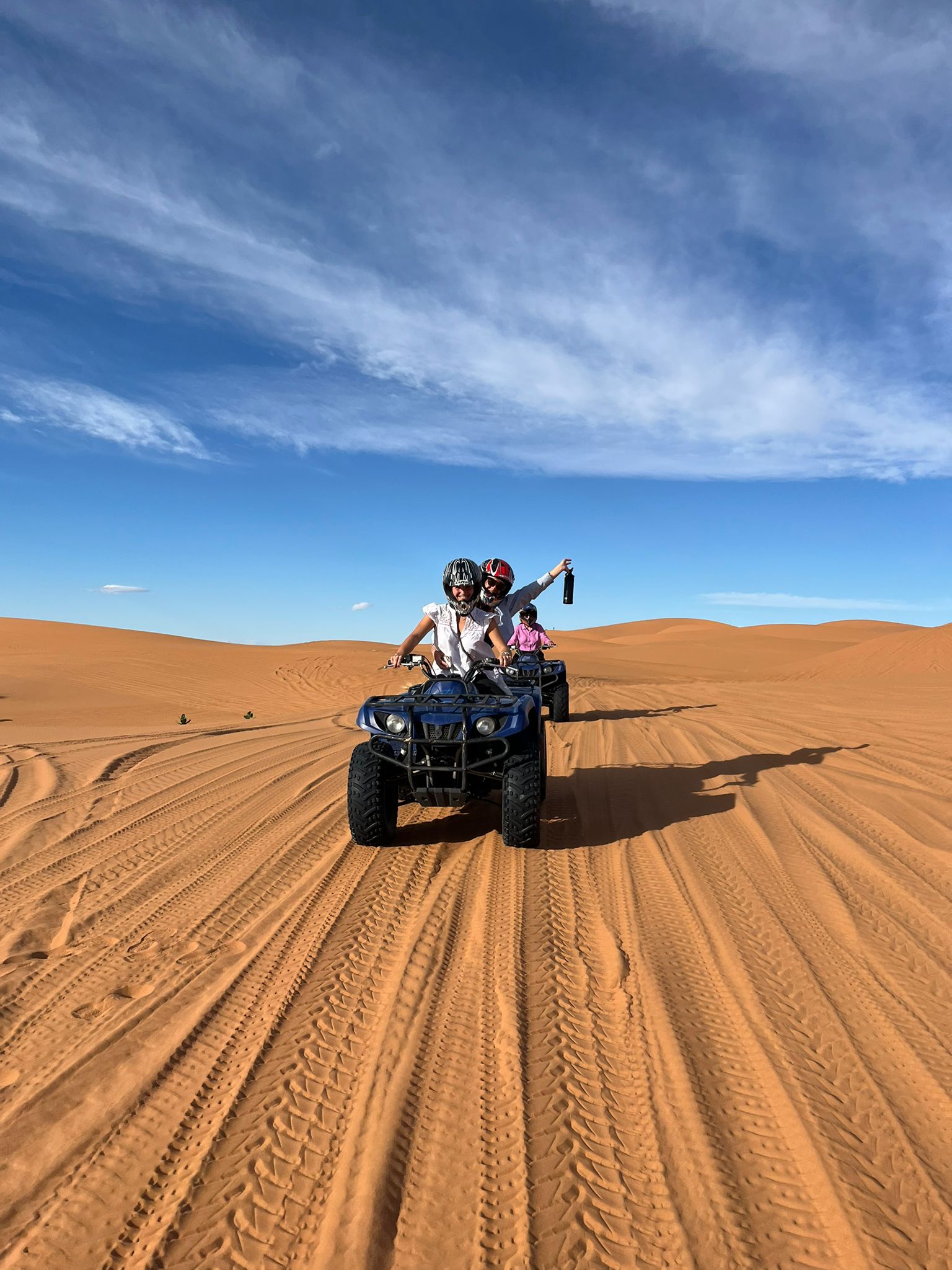 Camel caravan crossing the Erg Chebbi dunes at sunset on the Grand Morocco circuit